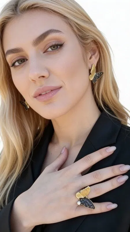 , These enchanting butterfly stud earrings capture the delicate beauty of nature with their whimsical design and lustrous freshwater pearls. Each earring features an intricately crafted brass butterfly silhouette with detailed wing patterns that catch and reflect light beautifully, creating subtle movement and visual interest.
The centerpiece of each earring is a luminous freshwater pearl that dangles gracefully beneath the butterfly motif, adding an elegant touch of sophistication to the playful design. The warm golden brass finish complements the creamy pearl tones perfectly, creating a harmonious color palette that enhances any complexion. The butterflies showcase detailed craftsmanship with textured wing surfaces that mimic the natural patterns found in nature.
These versatile earrings transition effortlessly from day to evening wear, making them perfect for both casual outfits and special occasions. Their compact stud design offers comfortable all-day wear while the dangling pearl elements provide just enough movement to catch attention. The nature-inspired motif adds a touch of whimsy to professional attire or enhances bohemian and romantic looks beautifully.
These earrings represent quality artisanal jewelry that celebrates both natural beauty and skilled craftsmanship. The combination of symbolic butterfly imagery and classic pearls creates a meaningful piece that speaks to transformation, growth, and timeless elegance. Their moderate size makes them suitable for various ear shapes and face types.
To maintain their beauty, gently clean with a soft cloth after wear and store in a dry place away from moisture and direct sunlight.