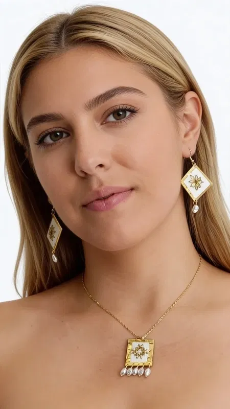 , This stunning statement pendant necklace showcases the exquisite beauty of traditional Greek embroidery reimagined for the modern woman. The centerpiece features a meticulously hand-embroidered textile panel adorned with delicate floral motifs, created using lustrous gold thread that catches and reflects light with every movement.
The intricate embroidery work is beautifully framed within a solid brass rectangular setting, creating a striking architectural contrast between the soft, nostalgic textile art and the strong metal framework. Four elegant freshwater pearls cascade gracefully from the bottom edge, adding movement and feminine sophistication to this heritage-inspired design.
Drawing inspiration from the rich tradition of Greek folk art, this piece celebrates the timeless craft of kentima (embroidery) while maintaining thoroughly contemporary appeal. The careful balance of cream-toned fabric, golden thread work, and warm brass creates a versatile palette that complements both casual and formal styling.
Perfect for the woman who appreciates artisanal craftsmanship and cultural heritage, this necklace transforms any outfit into a statement of refined elegance and artistic appreciation.
Care Instructions:
Store flat in a dry place. Gently clean brass with soft cloth. Avoid contact with perfumes and moisture on textile areas.