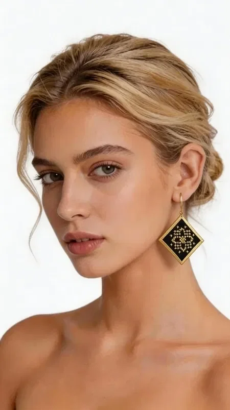 , The statement embroidered earrings with geometric patterns in gold thread on a black background are the perfect choice for every woman looking for striking and unique jewelry. Designed by Greek Jewelry Designer Aikaterini Chalkiadaki, these handmade earrings combine the traditional art of embroidery with contemporary geometric design.

Each earring features a square shape with intricate gold embroidery forming refined geometric motifs on a black base. The gold thread creates beautiful reflections of light, adding shine and elegance to every movement. These dangle earrings have an ideal size to make a statement without being excessive.

These modern earrings are ideal for special occasions, weddings, evening outings, and also for adding a touch of elegance to your everyday look. They pair perfectly with black, gold, or bold colors.

Material: Brass, Fabric

Take care of your embroidered earrings by storing them in a dry place and avoiding contact with perfumes and cosmetics.