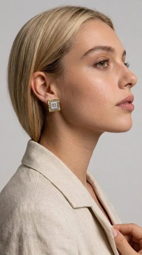 , The embroidered statement earrings with geometric patterns in a cream shade are the ideal choice for every woman who wants to add a unique, handmade touch to her style. With a square shape and detailed embroidery that creates striking geometric motifs, these earrings combine the tradition of folk embroidery with a modern, minimal aesthetic. Designed by Greek Jewelry Designer Aikaterini Chalkiadaki, they are a piece with authentic Greek character.

Made of brass and fabric, these earrings feature a gold metallic frame surrounding a delicate embroidered section in cream-white tones. The result is a piece of jewelry with depth of texture and character, equally suited to casual looks and formal occasions — from an everyday outfit with a linen blazer to an evening look or a wedding ceremony.

The geometric embroidered designs highlight the craftsmanship of handmade construction, while the cream shade ensures versatility when paired with neutral, earthy, or even bold color palettes.