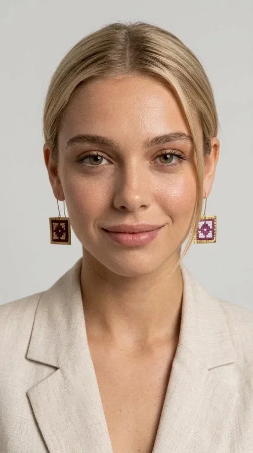 , The embroidered statement earrings in a vibrant magenta shade are the definition of jewelry that never goes unnoticed — a bold choice for those who love to express themselves through their style.

Designed by Greek Jewelry Designer Aikaterini Chalkiadaki, these striking handmade earrings combine geometric embroidered patterns in magenta and white, set within a square brass frame in a gold hue. The embroidery technique adds depth and texture to the piece, bringing forward a folk and folklore aesthetic that nods to Greek tradition in a modern way.

The dangling design with a delicate hook lets the earrings sway elegantly, elevating every look — from casual everyday outfits to evening outings, weddings, or festive occasions. The bold magenta hue pairs beautifully with neutral colors (white, beige, black) as well as with daring color combinations.