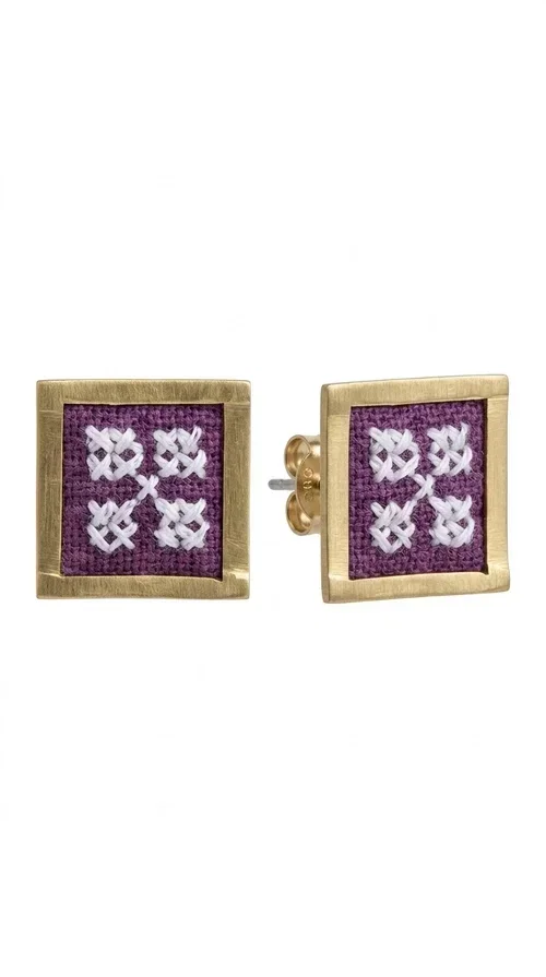 , The embroidered statement earrings with geometric designs in magenta are a bold choice for every woman who wants to express herself through her style. Designed by Greek Jewelry Designer Aikaterini Chalkiadaki, these handmade stud earrings combine folklore aesthetics with contemporary geometric composition, creating a result that immediately catches the eye.

Made from brass and fabric, they feature a square frame with a golden finish and an embroidered inner motif in a striking magenta shade, with delicate floral-geometric details reminiscent of traditional Greek folk art. The result is a jewelry piece with character and depth, ideal for elevating even the simplest outfit.

Perfect for weddings, christenings, nights out, or everyday looks that call for something extra, these earrings pair beautifully with white, black, or neutral clothing that lets the jewelry take center stage.