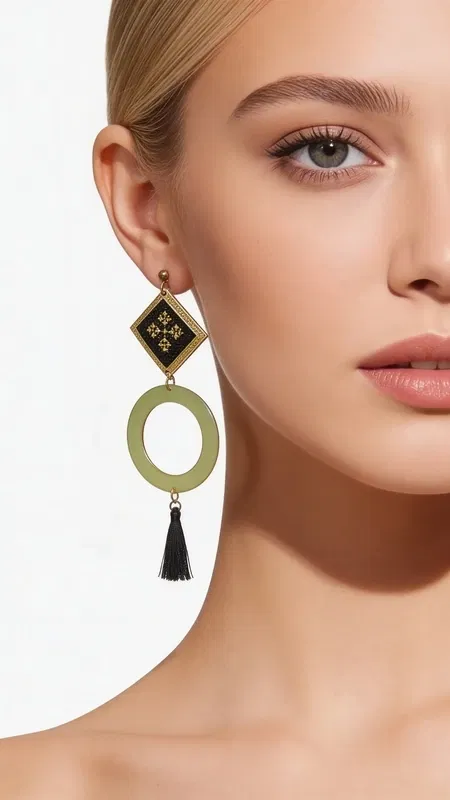 , Make a statement with these stunning geometric drop earrings that beautifully blend traditional Greek folk art with contemporary design. Each earring features an intricately embroidered black textile panel adorned with geometric motifs rendered in gleaming gold thread, creating a sophisticated contrast that catches the light with every movement.
The masterful craftsmanship showcases hand-stitched chrysoklosti (gold thread) detailing, with each geometric pattern meticulously embroidered onto rich black fabric. This textile artistry is elegantly framed in a solid brass diamond-shaped setting, which flows seamlessly into a circular brass element. The design culminates in a luxurious black tassel that adds movement and texture, creating an impressive statement piece that measures approximately 3-4 inches in length.
Inspired by the rich heritage of Greek embroidery traditions, these earrings celebrate the timeless art of kentima while offering a thoroughly modern interpretation for today's sophisticated woman.
These versatile statement pieces transition effortlessly from day to evening wear, adding artistic flair to both casual and formal ensembles. Perfect for the woman who appreciates handcrafted artistry and wants to make a memorable impression.
Care Instructions:
Store flat to prevent tangling. Clean brass elements with a soft cloth. Keep embroidered textiles dry and handle gently to preserve intricate stitching.