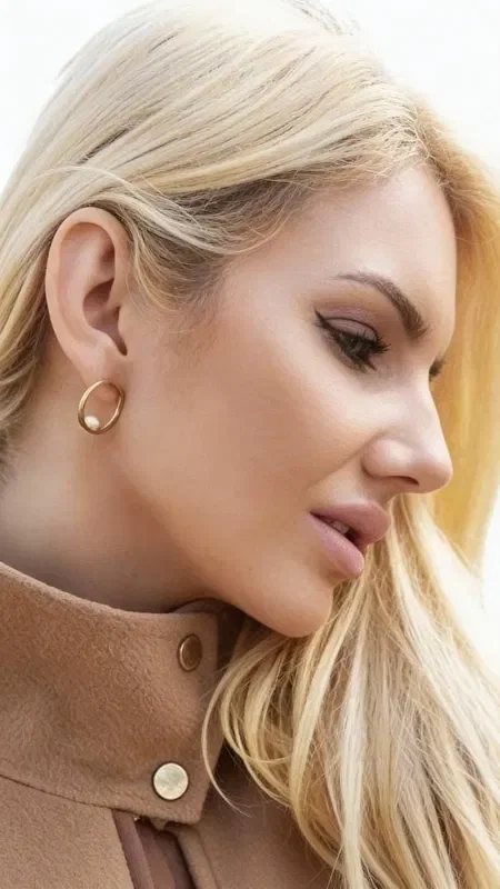 , Discover the perfect balance between minimalist elegance and timeless sophistication with these exquisite pearl earrings. Each piece is designed by Greek Jewelry Designer Aikaterini Chalkiadaki and represents a contemporary interpretation of classic style.

These handmade hoop earrings with pearls harmoniously combine golden brass with natural pearls, creating a striking result that completes any look. The geometric shape of the hoop offers a modern aesthetic, while the white pearls add a touch of classic femininity.

Ideal for everyday wear or special occasions, these women's earrings are subtle enough for the office and striking enough for evening outings. The quality of Greek craftsmanship is evident in every detail, from the metal finish to the placement of the pearls.