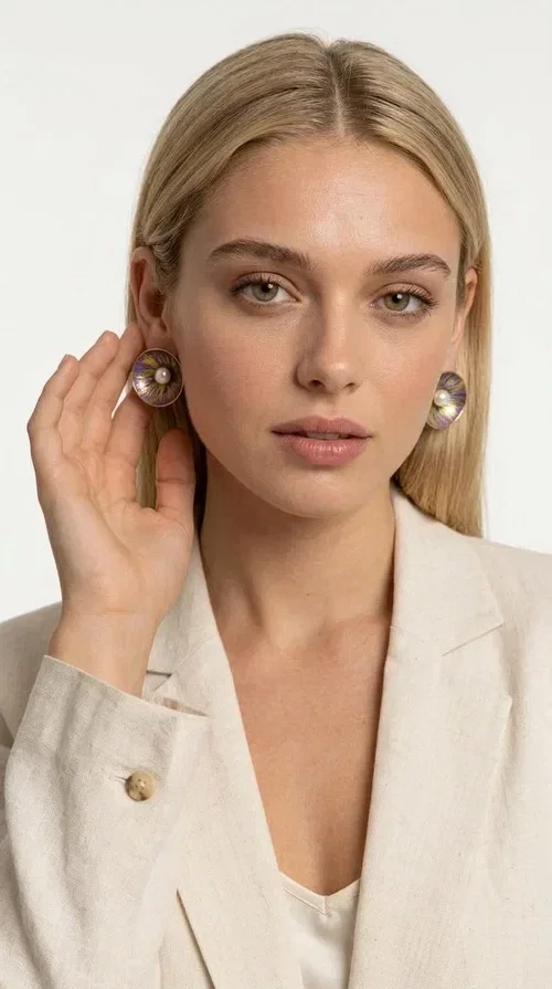 , Handmade purple stud earrings with pearls are an elegant choice for every woman seeking jewelry with character and feeling. Designed by Greek Jewelry Designer Aikaterini Chalkiadaki, these unique earrings combine refined aesthetics with the durability of brass and the warmth of handmade enamel, creating a result that truly stands out.

Each pair features a circular shape in a lilac-purple hue with golden brass details, while a natural pearl takes center stage, adding charm and femininity. The matte texture of the enamel combined with the soft shine of the pearl creates a contrast that makes the piece stand out both in everyday looks and in formal occasions, weddings and christenings.

Ideal as a gift or for personal use, they pair beautifully with minimal outfits, casual style, and formal looks alike. Their lightweight construction ensures comfort for everyday wear.