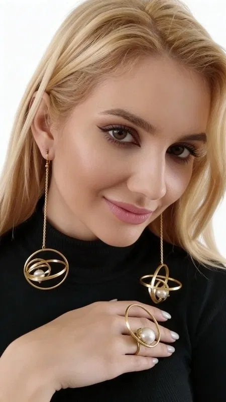 , These extraordinary statement earrings showcase the perfect marriage of contemporary geometric design and timeless pearl elegance. The spherical framework creates a captivating orbital effect, with lustrous freshwater pearls suspended gracefully within each golden circle, catching light from every angle as they move.
Expertly handcrafted with precision-engineered gold-plated brass, these striking pieces feature a sophisticated orbital design that transforms the classic pearl earring into a modern masterpiece. The generous length creates dramatic movement and visual impact, while the refined spherical silhouette adds architectural interest to any ensemble. Each freshwater pearl displays natural luminescence and subtle color variations that make every pair truly unique.
The innovative design philosophy behind these earrings draws inspiration from celestial mechanics and ancient Greek geometry, resulting in jewelry that feels both contemporary and eternally elegant. The substantial yet comfortable construction ensures they make a bold statement without compromising wearability. These versatile pieces transition seamlessly from professional settings to evening occasions, elevating everything from crisp blazers to flowing evening gowns.
Perfect for the confident woman who appreciates distinctive design and exceptional craftsmanship, these earrings complement both minimalist and maximalist styling approaches. The warm gold tones beautifully enhance all skin tones, while the pearl elements add sophistication and grace.
To maintain their lustrous finish, gently clean with a soft cloth after wearing and store separately to prevent scratching. Avoid contact with perfumes, lotions, and moisture to preserve the gold plating and pearl integrity.