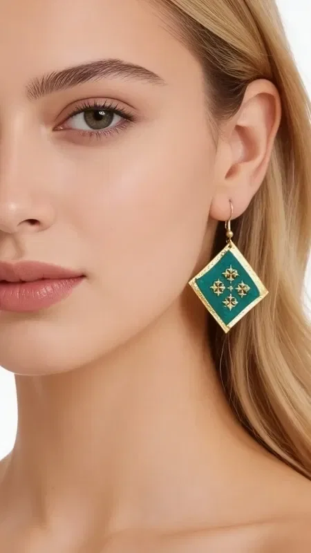 , Discover the magic of statement embroidered earrings with geometric patterns that turn any look into something striking. These unique handmade earrings, designed by Greek Jewelry Designer Aikaterini Chalkiadaki, feature a rich green color and gold thread that create a dazzling contrast.

Each earring is carefully embroidered with gold thread, forming geometric motifs that recall traditional Greek artistry with a modern aesthetic. The combination of vivid green with gold details offers an elegant look that suits both everyday wear and special occasions.

These statement earrings are ideal for women who want to stand out with style and confidence. Their unique folklore design makes them a perfect choice for weddings, evening outings, or any moment you want to feel special.

Care for them gently with a soft cloth and store them in a dry place to preserve their shine.