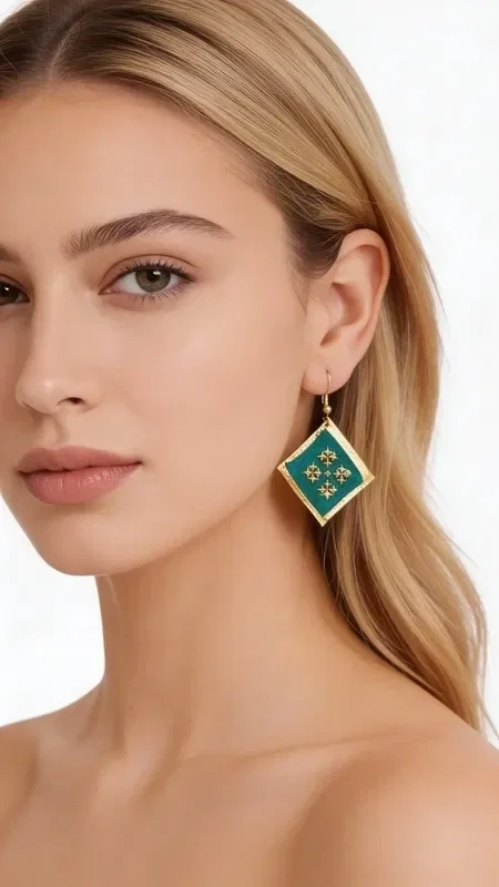 , Discover the magic of statement embroidered earrings with geometric patterns that turn any look into something striking. These unique handmade earrings, designed by Greek Jewelry Designer Aikaterini Chalkiadaki, feature a rich green color and gold thread that create a dazzling contrast.

Each earring is carefully embroidered with gold thread, forming geometric motifs that recall traditional Greek artistry with a modern aesthetic. The combination of vivid green with gold details offers an elegant look that suits both everyday wear and special occasions.

These statement earrings are ideal for women who want to stand out with style and confidence. Their unique folklore design makes them a perfect choice for weddings, evening outings, or any moment you want to feel special.

Care for them gently with a soft cloth and store them in a dry place to preserve their shine.
