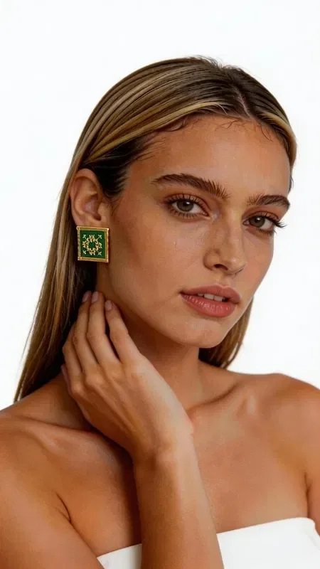 , Stand out with these striking statement earrings, embroidered with gold thread in a vibrant green color that combines the traditional art of embroidery with a modern aesthetic. Designed by Greek Jewelry Designer Aikaterini Chalkiadaki, these handmade earrings feature geometric patterns inspired by Greek folklore. Each earring is a unique work of art, embroidered with detail and care.

The rich green color combined with gold accents creates a striking combination that suits both everyday and formal looks. Their square shape gives them a modern aesthetic, while the handmade construction guarantees high quality.

Ideal for every occasion, from casual outings to weddings and formal evening events. Pair them with monochrome outfits to highlight their beauty, or create bohemian looks that express your personality.

Material: Brass, Fabric
Care: Store in a dry place away from moisture and direct sunlight.
