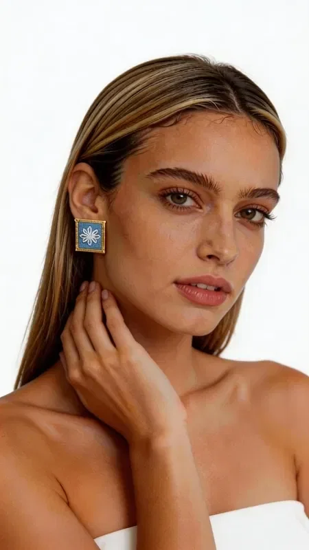 , Discover the magic of embroidered statement earrings with geometric designs in gold thread on a striking light blue background. These exceptional handmade earrings, designed by Greek Jewelry Designer Aikaterini Chalkiadaki, combine the traditional art of embroidery with a contemporary aesthetic.

Each earring is adorned with intricate geometric motifs embroidered in gold thread on a vivid light blue background, creating a unique embroidery reminiscent of traditional Greek craftsmanship. The square shape and gold outline add an elegant touch that makes these striking earrings ideal for any occasion.

These statement earrings are perfect for completing a bridal look, an elegant festive appearance, or even a casual outfit you want to stand out. The high-quality craftsmanship and original design make them a unique piece that will elevate your style.

Material: Brass, Fabric

Handle with care, avoiding contact with water and perfumes to preserve the colors.