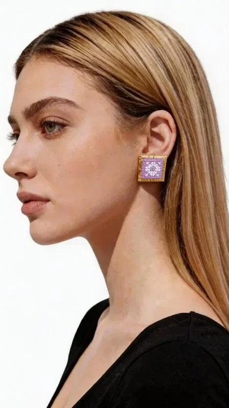 , Embroidered statement earrings with geometric patterns in lilac color are the perfect choice for women who want to stand out with style and elegance. Designed by Greek Jewelry Designer Aikaterini Chalkiadaki, these striking handmade earrings combine the traditional art of embroidery with contemporary design. The square shape with intricate geometric motifs creates a unique visual effect that complements any look. The gold thread used in the embroidery adds shine and luxury, while the lilac color adds a touch of femininity and elegance.

These statement earrings are ideal for special events, evening outings, or even for a bridal look. They pair perfectly with monochrome outfits and add a bold splash of color to any ensemble.

Material: Brass, Fabric

To preserve their beauty, store the earrings in a dry place and avoid contact with moisture and perfumes.