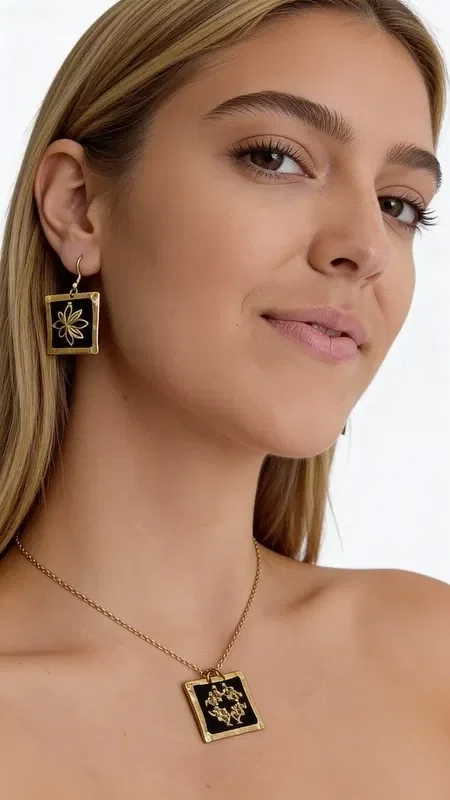 , These embroidered statement earrings with gold thread on a black background are a striking choice that combines the traditional Greek art of embroidery with modern design. Designed by Greek Jewelry Designer Aikaterini Chalkiadaki, these handmade earrings stand out for their exceptional quality and unique aesthetic.

The geometric patterns in gold thread create a striking visual contrast against the black base, offering elegance and style. Their square shape and dangling design make them ideal for special occasions such as weddings or christenings, or for adding a striking touch to your everyday look.

These modern embroidered earrings are perfect for women who love statement jewelry and are looking for something special and original. The art of handmade embroidery gives each piece uniqueness and authenticity. Be sure to store them in a dry place and clean them gently with a soft cloth to preserve their beauty.