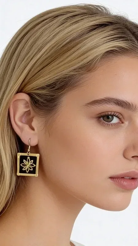 , These embroidered statement earrings with gold thread on a black background are a striking choice that combines the traditional Greek art of embroidery with modern design. Designed by Greek Jewelry Designer Aikaterini Chalkiadaki, these handmade earrings stand out for their exceptional quality and unique aesthetic.

The geometric patterns in gold thread create a striking visual contrast against the black base, offering elegance and style. Their square shape and dangling design make them ideal for special occasions such as weddings or christenings, or for adding a striking touch to your everyday look.

These modern embroidered earrings are perfect for women who love statement jewelry and are looking for something special and original. The art of handmade embroidery gives each piece uniqueness and authenticity. Be sure to store them in a dry place and clean them gently with a soft cloth to preserve their beauty.