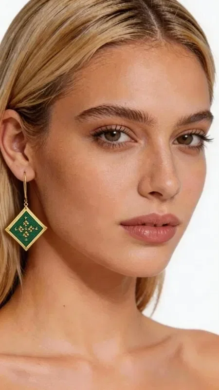 , These striking embroidered statement earrings with a geometric design will become the ultimate accessory for every look. Their square shape in a green shade with golden details creates a unique aesthetic that combines modern style with the traditional art of embroidery.

Designed by Greek Jewelry Designer Aikaterini Chalkiadaki, these handmade earrings stand out for the exceptional quality of the gold thread and the contemporary interpretation of geometric motifs. The green color adds freshness and vibrancy, while the golden details highlight the elegance of the design.

These dangle earrings are ideal for evening outings, special occasions, or whenever you want to add a touch of style to your everyday look. Their unique shape and color scheme make them completely versatile, pairing perfectly with monochrome outfits and adding an impressive character.

Material: Brass, Fabric

Care for your earrings by storing them in a dry place and gently cleaning them with a soft cloth.