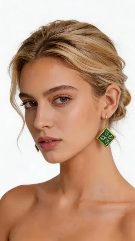 , Striking embroidered statement earrings that combine the traditional art of embroidery with contemporary geometric design. Designed by Greek Jewelry Designer Aikaterini Chalkiadaki, these unique handmade earrings in green will become the focal point of any outfit. The refined diamond shape with its detailed gold-thread embroidered motifs creates an elegant contrast with the vivid green color. Each earring is handmade with special attention to detail, combining folklore design elements with a modern aesthetic. Ideal for weddings, special occasions, or whenever you want to add a touch of color and elegance to your everyday look. Their lightweight design makes them comfortable for all-day wear. Store the earrings in a dry place, avoiding contact with water and chemical products to preserve their shine and beauty.