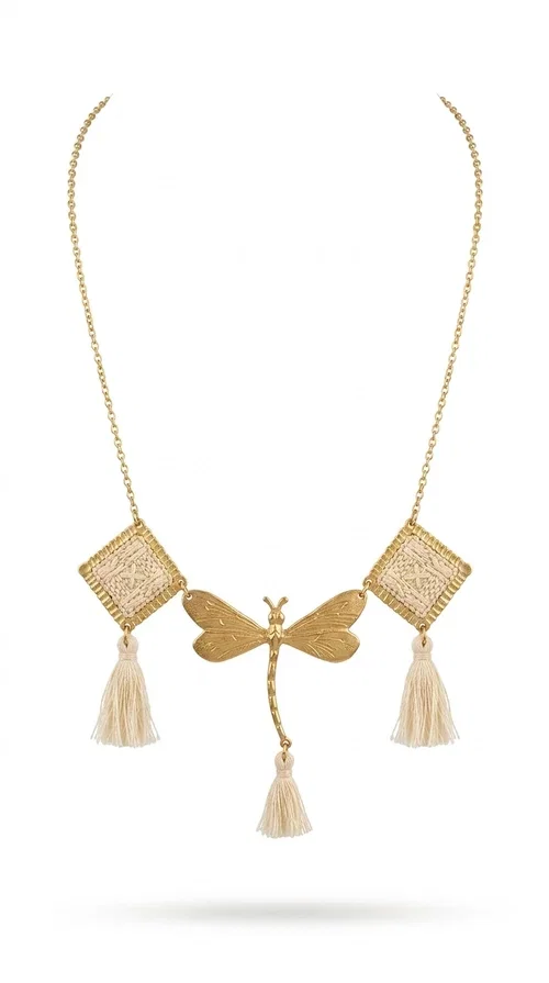 , An embroidered necklace that blends folk aesthetics with modern elegance — the Statement necklace KOL-4771 is the ideal choice for those seeking jewelry with character and warmth.

Designed by Greek Jewelry Designer Aikaterini Chalkiadaki, this necklace is a handmade work of art inspired by Greek folklore aesthetics. Made of brass and fabric, it features geometric embroidered motifs in gold tones alternating with a central butterfly motif, while four ivory fabric tassels add movement and boho-chic flair. The ivory and gold palette creates a timelessly elegant combination, suitable for every season.

Wear it with a white linen shirt or a simple dress to fully showcase its beauty. Ideal for summer looks, weddings, christenings, or even for everyday outings that call for something special.