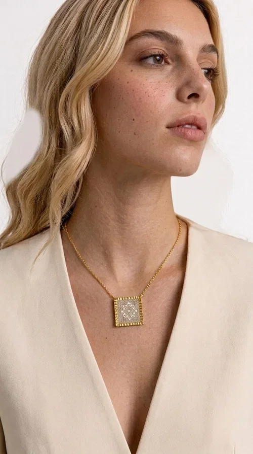 , A statement embroidered necklace that combines tradition with contemporary style — ideal for those who love striking jewelry with character. Designed by Greek Jewelry Designer Aikaterini Chalkiadaki, this handmade necklace features geometric embroidered patterns in cream tones, inspired by folk art and Greek tradition. The square pendant with a brass frame and fabric surface makes for a unique piece of jewelry that stands out from the ordinary.

The delicate gold-tone chain highlights the pendant, making it stand out in both casual and more formal looks. The geometric embroidered motifs give a sense of vintage elegance, while the cream tones make it versatile — pairing well with dresses, jackets, and even casual outfits. An ideal gift for women who appreciate handmade jewelry with a Greek soul.