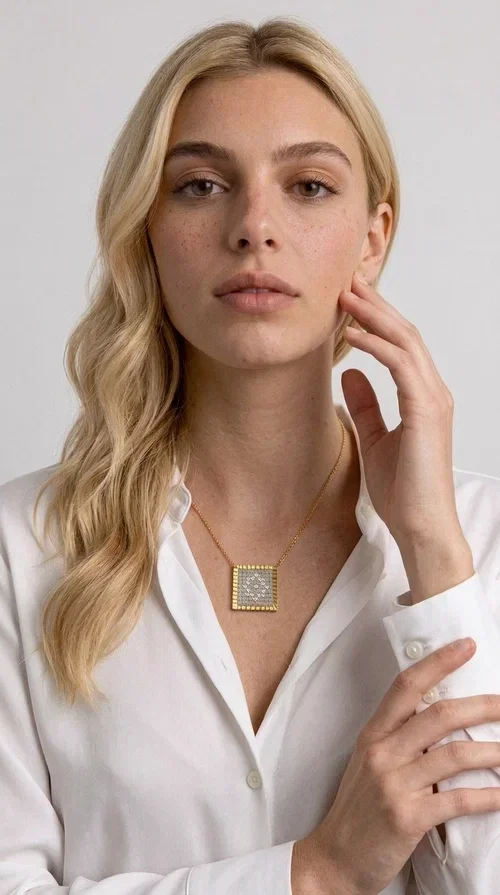 , A statement embroidered necklace that combines tradition with contemporary style — ideal for those who love striking jewelry with character. Designed by Greek Jewelry Designer Aikaterini Chalkiadaki, this handmade necklace features geometric embroidered patterns in cream tones, inspired by folk art and Greek tradition. The square pendant with a brass frame and fabric surface makes for a unique piece of jewelry that stands out from the ordinary.

The delicate gold-tone chain highlights the pendant, making it stand out in both casual and more formal looks. The geometric embroidered motifs give a sense of vintage elegance, while the cream tones make it versatile — pairing well with dresses, jackets, and even casual outfits. An ideal gift for women who appreciate handmade jewelry with a Greek soul.