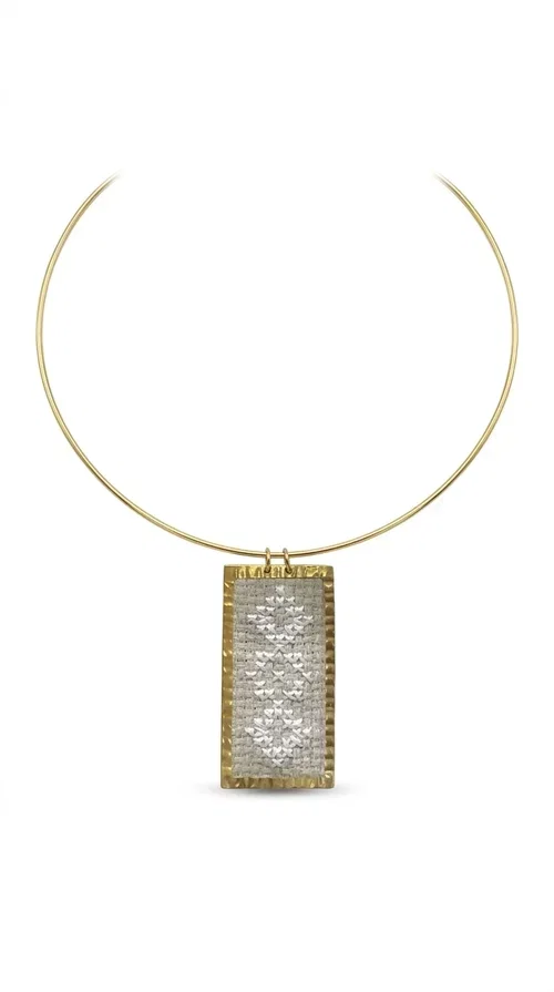 , A statement embroidered necklace that instantly catches the eye — featuring geometric patterns in cream tones and an aesthetic that blends folk tradition with contemporary style. Designed by Greek Jewelry Designer Aikaterini Chalkiadaki, this handmade piece is a distinctive choice for those seeking something beyond the ordinary.

The rectangular embroidered pendant in cream-gold tones is crafted from brass and fabric, featuring dense embroidery in geometric motifs reminiscent of folklore aesthetics. It hangs from a delicate gold-toned choker-torque style chain that elegantly and strikingly highlights the neckline. The extensive decoration with small shimmering elements adds richness and depth to the overall composition.

Ideal for casual chic or smart casual looks, it pairs beautifully with a white T-shirt, a blazer, or a summer dress. It also makes an excellent gift idea for women who appreciate handmade jewelry with a distinctive character.