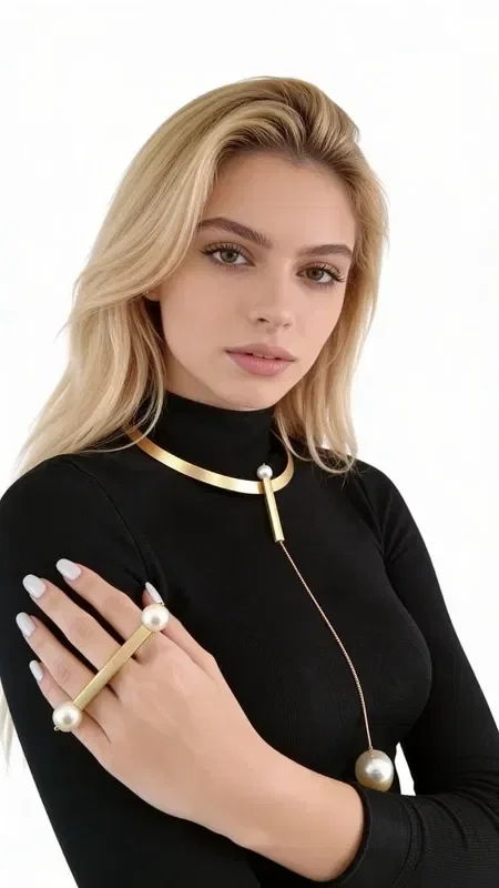 , Discover the unique beauty of this statement long necklace with pearls, a striking piece of jewelry that combines elegance with a modern aesthetic. Designed by Greek Jewelry Designer Aikaterini Chalkiadaki, this handmade necklace is the perfect choice for women who love eye-catching accessories.

The long necklace features a minimalist gold collar that holds an elegant pearl pendant, creating a statement look that stands out. The geometric line and golden hue add modern luxury, while the pearl at the bottom adds femininity and elegance.

Ideal for layering with other necklaces or wearing on its own for special occasions, this neck jewelry becomes the focal point of any look. It pairs perfectly with both casual and elegant outfits, from sweaters to dresses.

Care for your necklace by storing it in a dry place and gently cleaning it with a soft cloth.