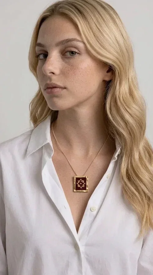 , The embroidered burgundy necklace with geometric patterns is a statement piece that combines the traditional art of embroidery with a contemporary aesthetic, creating a unique result that instantly catches the eye.

Designed by Greek Jewelry Designer Aikaterini Chalkiadaki, this handmade necklace features a square brass pendant with deep burgundy fabric and a striking embroidered geometric motif inspired by Greek folk tradition. The gold-toned brass metal frame surrounds the embroidery, giving the piece a vintage, luxurious feel. The delicate gold-tone chain highlights the pendant, making it the ultimate focal point of any look.

Ideal for pairing with a casual white shirt, a dress, or elegant attire for an evening out, this necklace is equally suited to everyday and formal occasions. It also makes an excellent gift choice for loved ones who appreciate unique, handmade jewelry with a Greek soul.