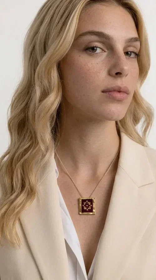 , The embroidered burgundy necklace with geometric patterns is a statement piece that combines the traditional art of embroidery with a contemporary aesthetic, creating a unique result that instantly catches the eye.

Designed by Greek Jewelry Designer Aikaterini Chalkiadaki, this handmade necklace features a square brass pendant with deep burgundy fabric and a striking embroidered geometric motif inspired by Greek folk tradition. The gold-toned brass metal frame surrounds the embroidery, giving the piece a vintage, luxurious feel. The delicate gold-tone chain highlights the pendant, making it the ultimate focal point of any look.

Ideal for pairing with a casual white shirt, a dress, or elegant attire for an evening out, this necklace is equally suited to everyday and formal occasions. It also makes an excellent gift choice for loved ones who appreciate unique, handmade jewelry with a Greek soul.