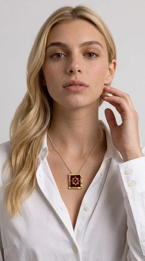 , The embroidered burgundy necklace with geometric patterns is a statement piece that combines the traditional art of embroidery with a contemporary aesthetic, creating a unique result that instantly catches the eye.

Designed by Greek Jewelry Designer Aikaterini Chalkiadaki, this handmade necklace features a square brass pendant with deep burgundy fabric and a striking embroidered geometric motif inspired by Greek folk tradition. The gold-toned brass metal frame surrounds the embroidery, giving the piece a vintage, luxurious feel. The delicate gold-tone chain highlights the pendant, making it the ultimate focal point of any look.

Ideal for pairing with a casual white shirt, a dress, or elegant attire for an evening out, this necklace is equally suited to everyday and formal occasions. It also makes an excellent gift choice for loved ones who appreciate unique, handmade jewelry with a Greek soul.