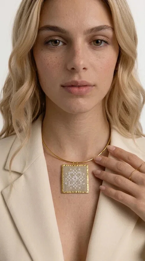 , The statement necklace embroidered with geometric patterns is a jewelry piece that instantly grabs attention — bold, handmade and full of character. Designed by Greek Jewelry Designer Aikaterini Chalkiadaki, it combines the tradition of embroidery art with a modern aesthetic result that suits both day and evening wear. The brass collar holds a square embroidered pendant in deep burgundy color, decorated with delicate geometric motifs inspired by Greek folk tradition.

This necklace is not just an accessory — it's a style statement. The embroidered fabric in burgundy shade, framed by golden brass, creates a striking contrast that enhances every outfit. Ideal to be worn over a simple white or ecru shirt, or to complete an evening look, it offers that unique balance between boho and minimal style.