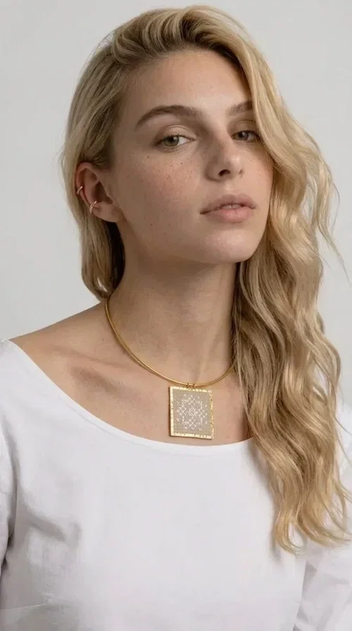 , The statement necklace embroidered with geometric patterns is a jewelry piece that instantly grabs attention — bold, handmade and full of character. Designed by Greek Jewelry Designer Aikaterini Chalkiadaki, it combines the tradition of embroidery art with a modern aesthetic result that suits both day and evening wear. The brass collar holds a square embroidered pendant in deep burgundy color, decorated with delicate geometric motifs inspired by Greek folk tradition.

This necklace is not just an accessory — it's a style statement. The embroidered fabric in burgundy shade, framed by golden brass, creates a striking contrast that enhances every outfit. Ideal to be worn over a simple white or ecru shirt, or to complete an evening look, it offers that unique balance between boho and minimal style.