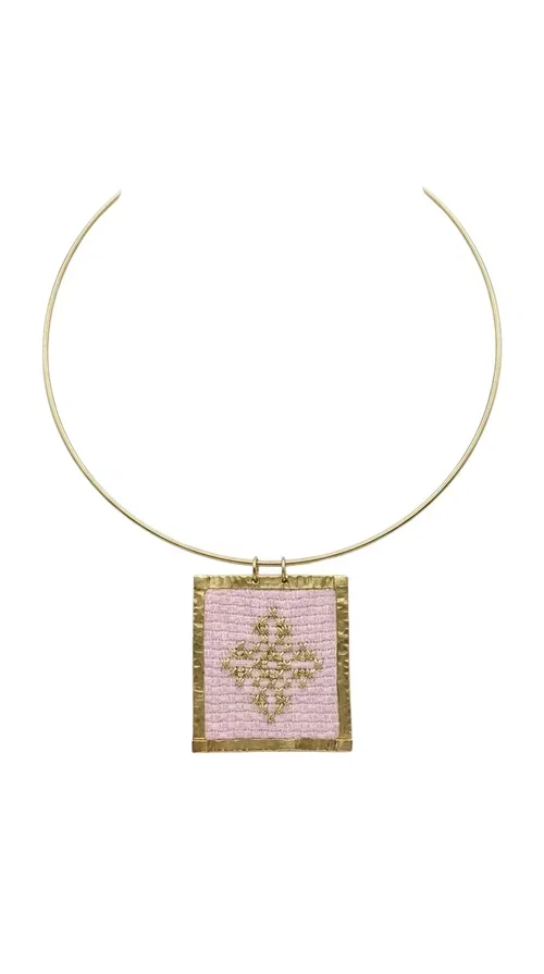 , An embroidered necklace that combines the traditional art of embroidery with modern design, creating a piece of jewelry that stands out instantly.

Designed by Greek Jewelry Designer Aikaterini Chalkiadaki, this statement necklace features a rectangular embroidered motif in soft pink tones with gold geometric details inspired by Greek folk tradition. The gold brass frame highlights the embroidered fabric, while the delicate semicircular chain gives the whole piece an airy and elegant character.

Ideal for women who love striking jewelry with soul, this handmade necklace pairs perfectly with both casual and more formal outfits — just as shown here over a classic beige jacket. Bring folk aesthetics into your everyday look in a completely modern way.