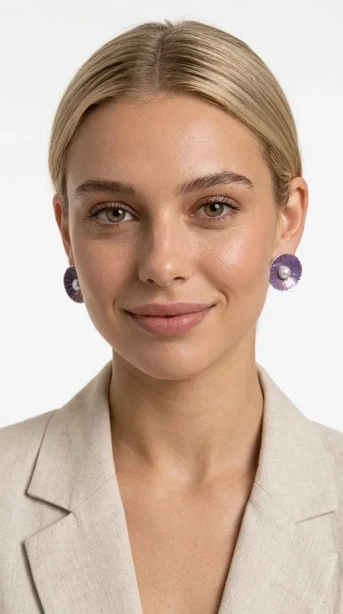 , Stud earrings with pearls in a purple hue are an elegant choice that combines the feel of vintage aesthetics with modern design. Designed by Greek Jewelry Designer Aikaterini Chalkiadaki, these handmade earrings are a distinctive addition to the collection of any woman who loves authentic jewelry.

The circular shape with its ribbed brass surface, covered in deep purple enamel, showcases a shimmering pearl at its center, creating an effect reminiscent of a blooming flower. This refined design suits both everyday outfits and formal occasions, from corporate meetings to weddings and christenings.

These purple pearl earrings make an ideal gift for loved ones, as they are handmade with attention to detail and crafted from quality materials that ensure long-lasting wear.
