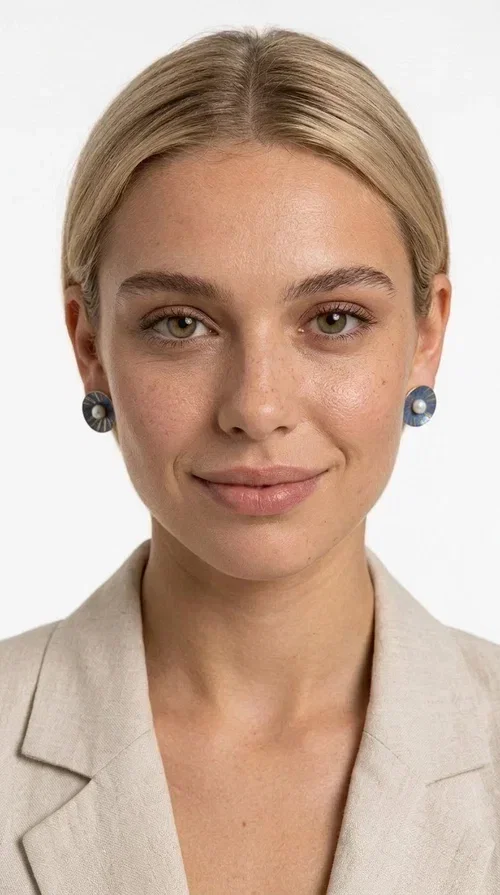, These handmade stud earrings with pearls in deep blue color are an elegant choice for every woman seeking jewelry with character and quality. Designed by Greek Jewelry Designer Aikaterini Chalkiadaki, these earrings combine the traditional art of enamel with the timeless beauty of the pearl, creating a result that truly stands out.

The circular brass shape with a relief surface in a radiant sunburst pattern gives the piece an open, flower-like character. The blue-toned enamel evenly covers the base, while at the center a white pearl stands out, adding finesse and contrast. Their stud design makes them ideal for everyday wear, as well as for formal occasions.

Wear them paired with linen or neutral outfits to highlight their color palette, or choose them as a statement piece for weddings, christenings, and every special moment.