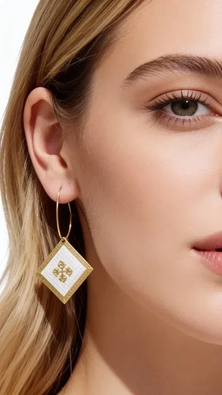 , The statement embroidered earrings with geometric patterns in gold thread on white make the perfect choice for the modern woman seeking striking handmade jewelry. Designed by Greek Jewelry Designer Aikaterini Chalkiadaki, they combine traditional embroidery techniques with a modern aesthetic.

Each earring is crafted with careful handwork, using gold thread that forms impressive geometric motifs on a white base. The distinctive design with diamond-like details adds shine and elegance, making them ideal for special occasions and weddings.

The embroidered earrings feature a raised texture that highlights their handmade character, while the golden details create beautiful contrasts against the white background. They are striking enough to become the focal point of your look. Keep your earrings in a dry place and avoid contact with perfumes and creams to preserve their shine.