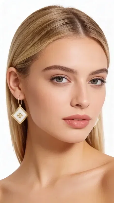 , The statement embroidered earrings with geometric patterns in gold thread on white make the perfect choice for the modern woman seeking striking handmade jewelry. Designed by Greek Jewelry Designer Aikaterini Chalkiadaki, they combine traditional embroidery techniques with a modern aesthetic.

Each earring is crafted with careful handwork, using gold thread that forms impressive geometric motifs on a white base. The distinctive design with diamond-like details adds shine and elegance, making them ideal for special occasions and weddings.

The embroidered earrings feature a raised texture that highlights their handmade character, while the golden details create beautiful contrasts against the white background. They are striking enough to become the focal point of your look. Keep your earrings in a dry place and avoid contact with perfumes and creams to preserve their shine.