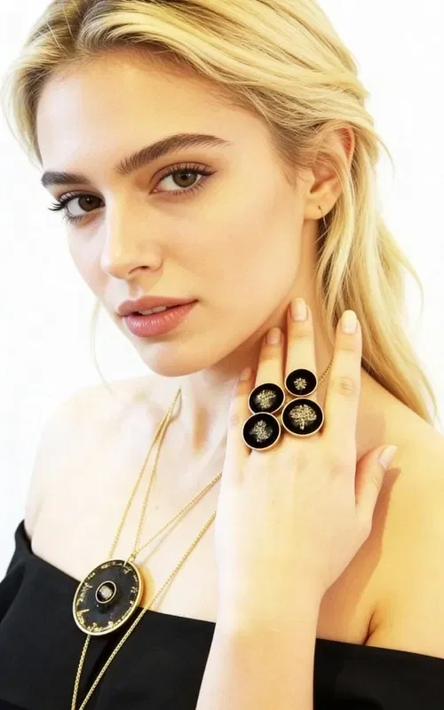 , Discover the magic of the handmade women's ring with pyrite, a unique piece of jewelry that combines the power of natural stones with modern aesthetics. Designed by Greek Jewelry Designer Aikaterini Chalkiadaki, this striking ring is the perfect choice for women seeking statement jewelry with character.

The oval silhouette of the ring is surrounded by golden brass, while the center is dominated by a black patina that holds a natural iron pyrite stone. The pyrite offers metallic reflections that create a mesmerizing visual dialogue with the black background.

The large size of the ring makes it ideal for those who prefer striking jewelry that stands out. The handmade construction guarantees the uniqueness of each piece, making it a true work of art.
